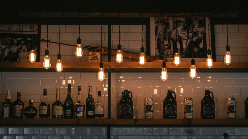 assorted wine bottle on brown shelf