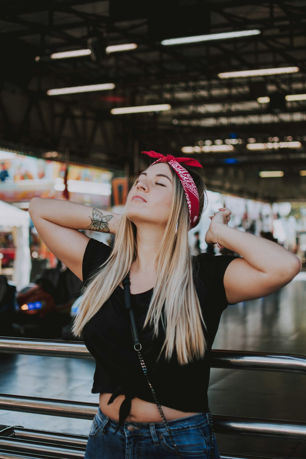 woman wearing black crop top and blue denim bottoms