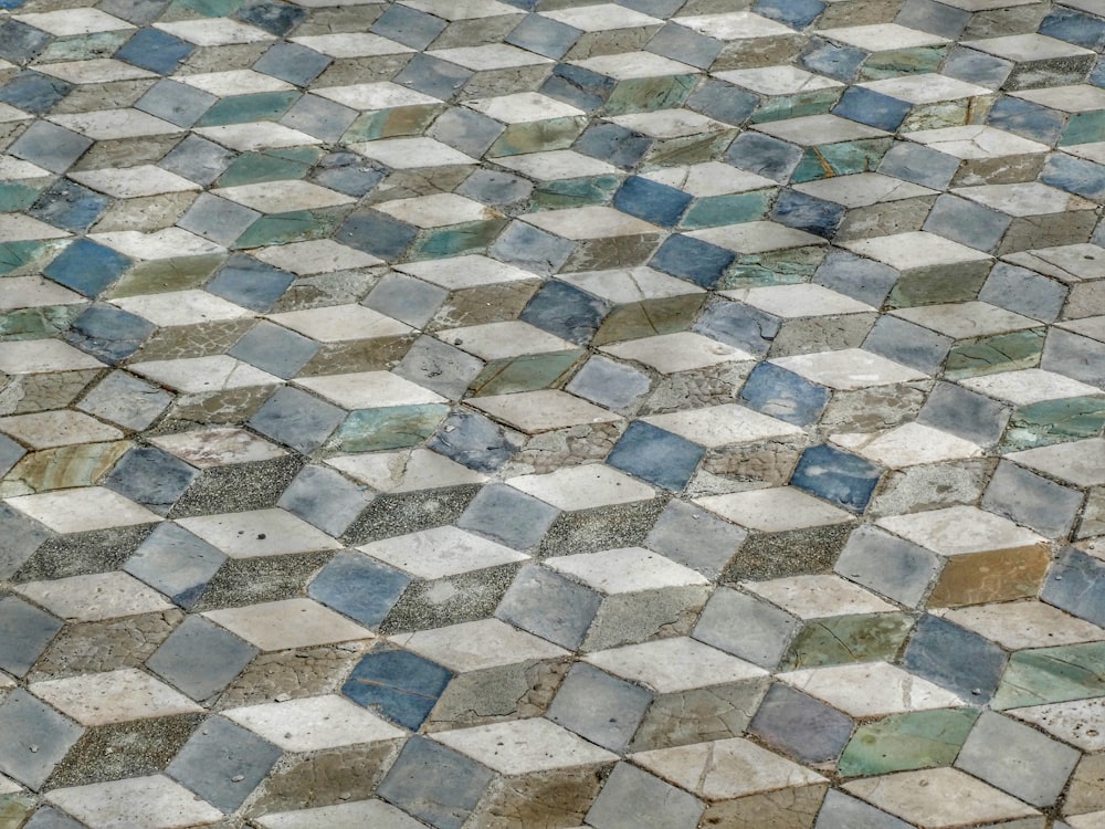 a close up of a tiled floor with blue and white tiles