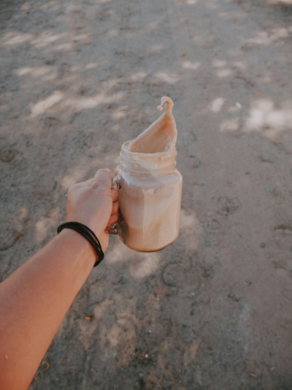 person holding mason jar