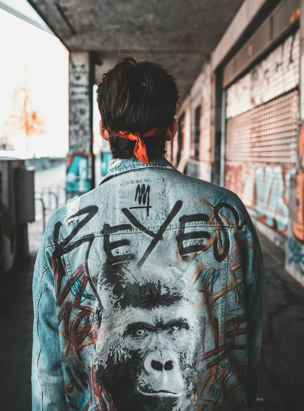 man wearing teal denim jacket