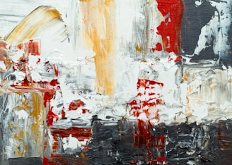 A textured abstract painting with thick, bold brushstrokes in various directions. The artwork features a mix of colors, including red, white, black, and ochre, blending together in a chaotic yet harmonious pattern.