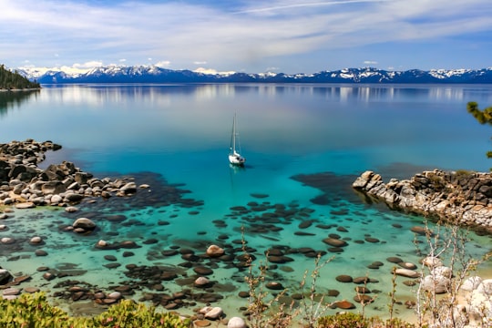 white boat on calm body of water in Lake Tahoe United States