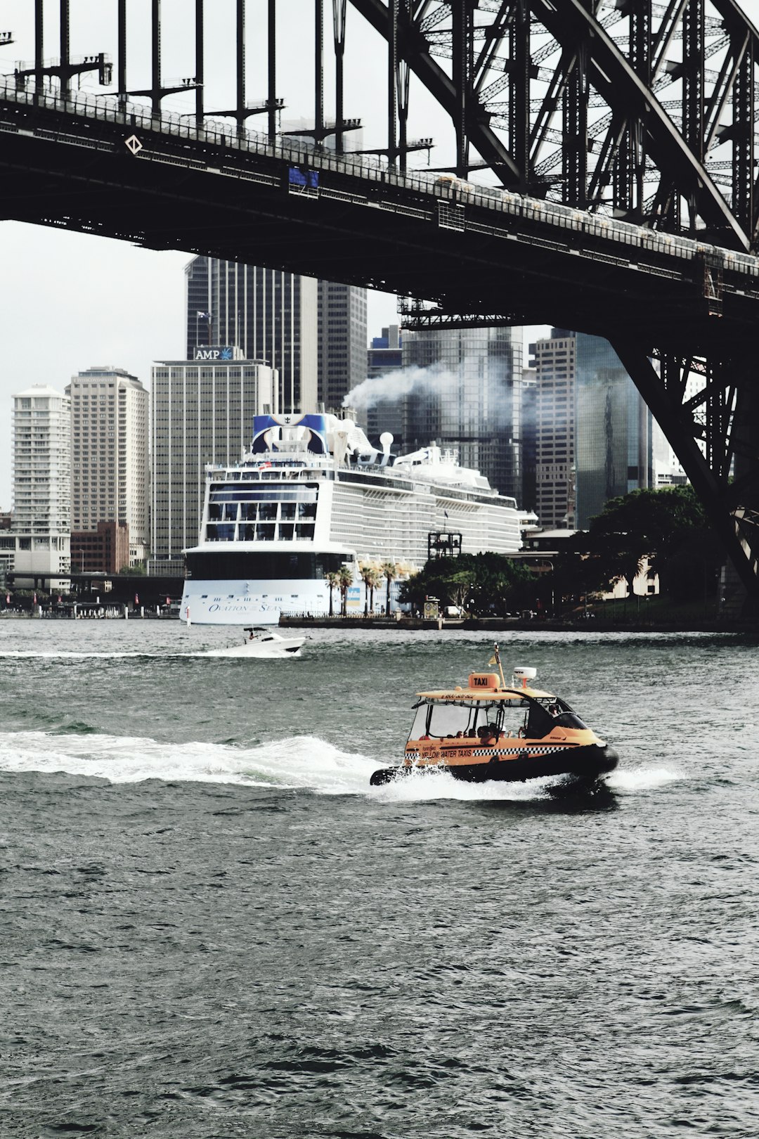 orange bow rider on under bridge on calm water