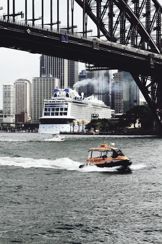 orange bow rider on under bridge on calm water in Sydney Harbour Bridge Australia