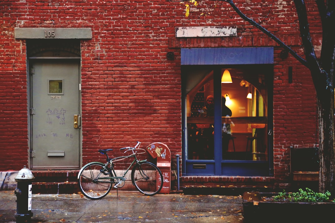 black bike leaning by building door