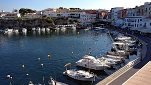 A classic New England coastal village with colorful boats docked at the harbor.