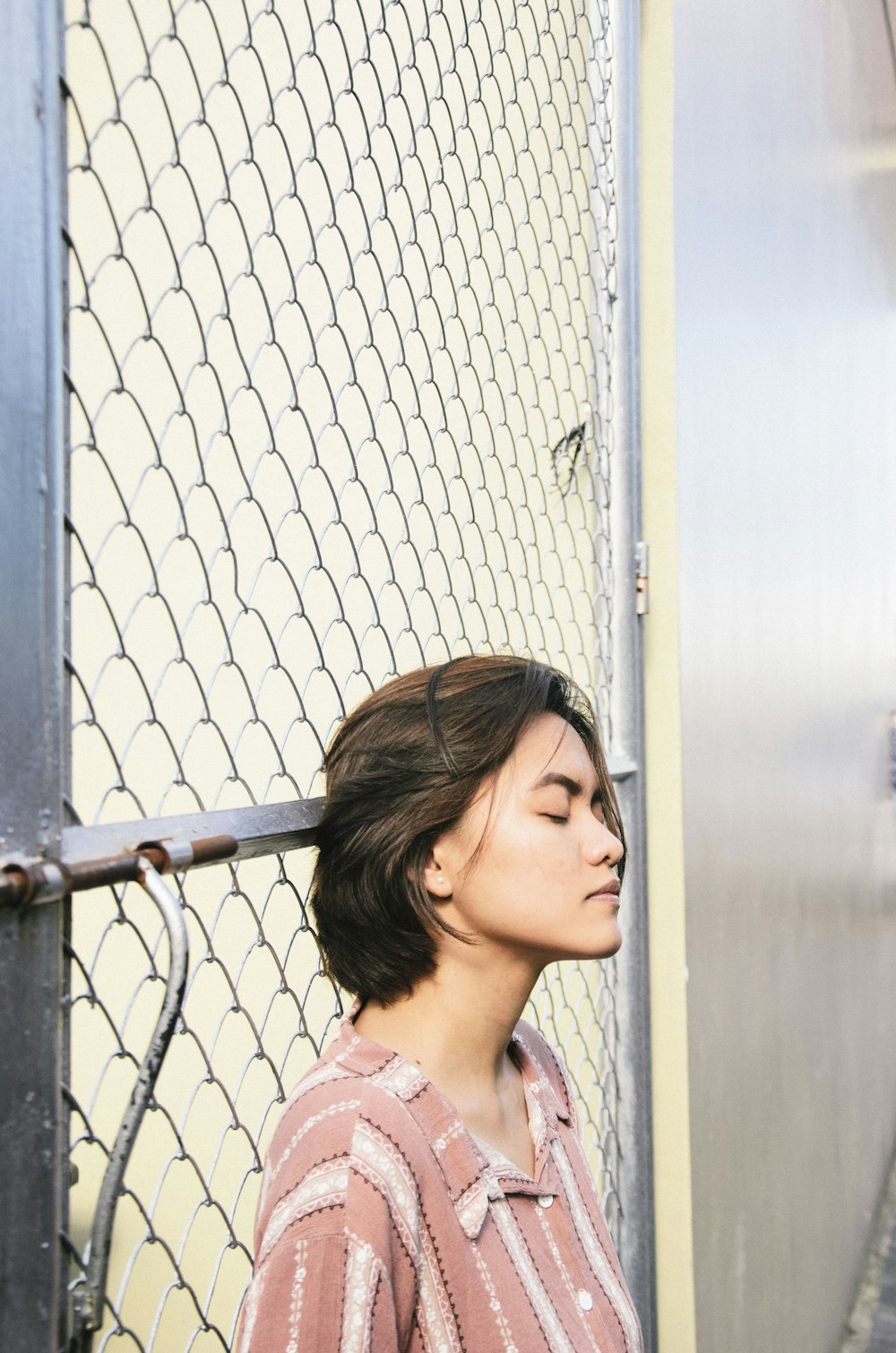 woman standing near wire fence