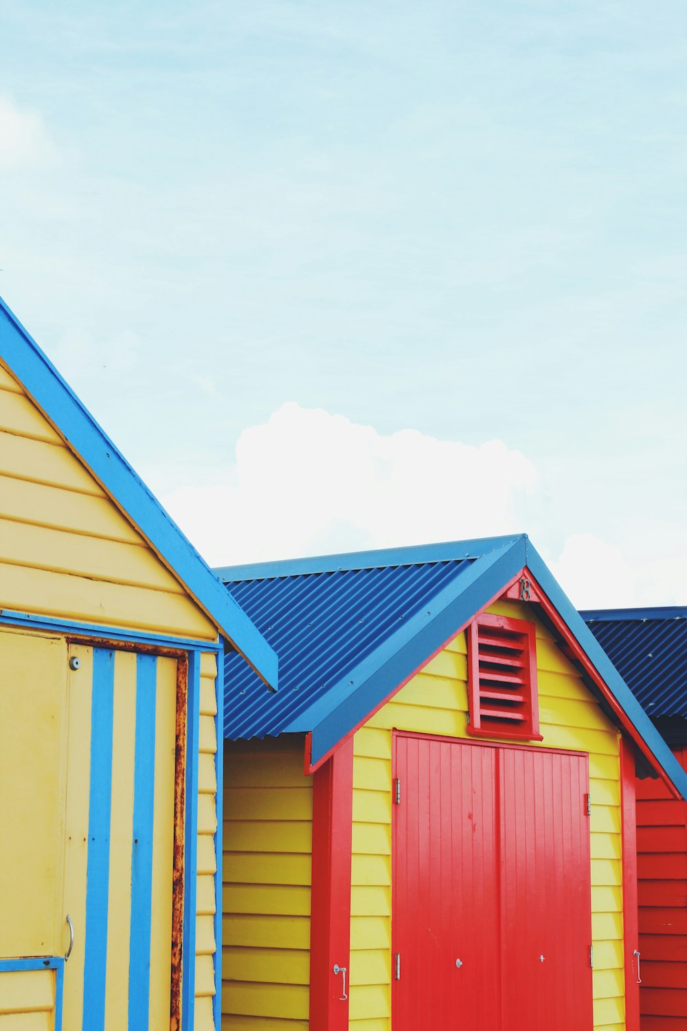 yellow, red, and blue house during daytime