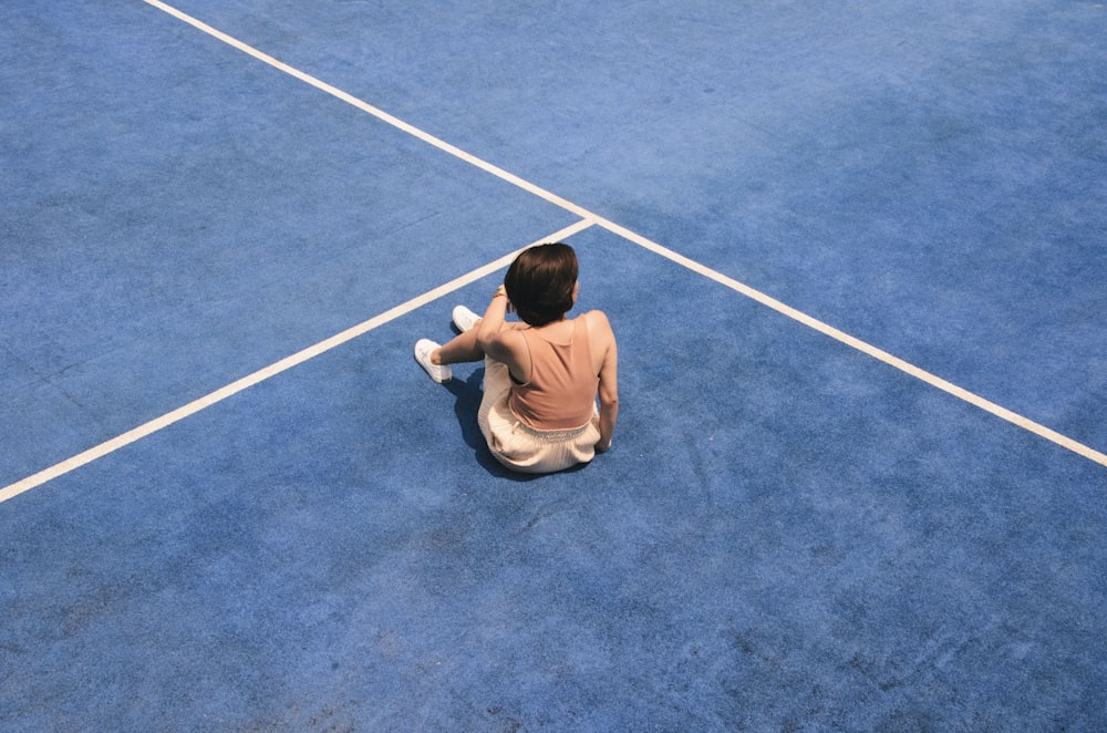 woman sitting on blue floor