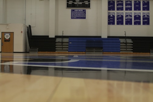 A welcoming community center with sports equipment and vibrant banners in navy, white, and gold.