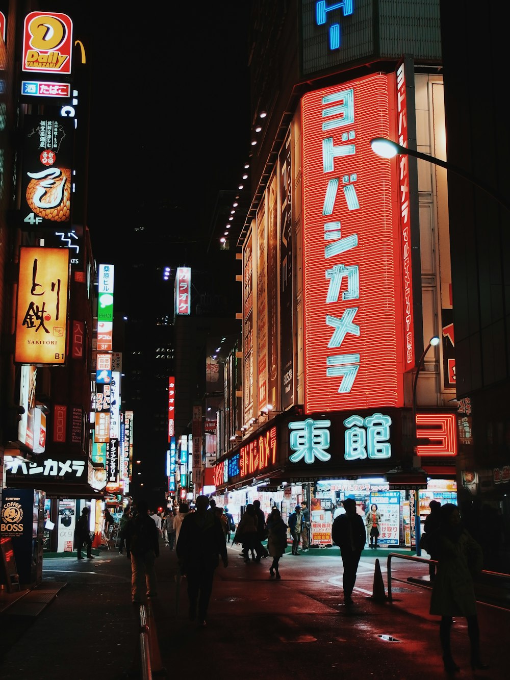 people walking on street with E-billboards