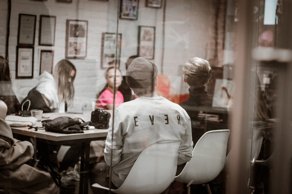 people sitting beside table inside room