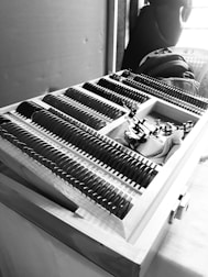 Optical lenses and tools arranged neatly on a workbench.