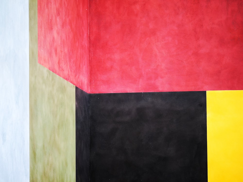a painting of a red, yellow, black, and green wall
