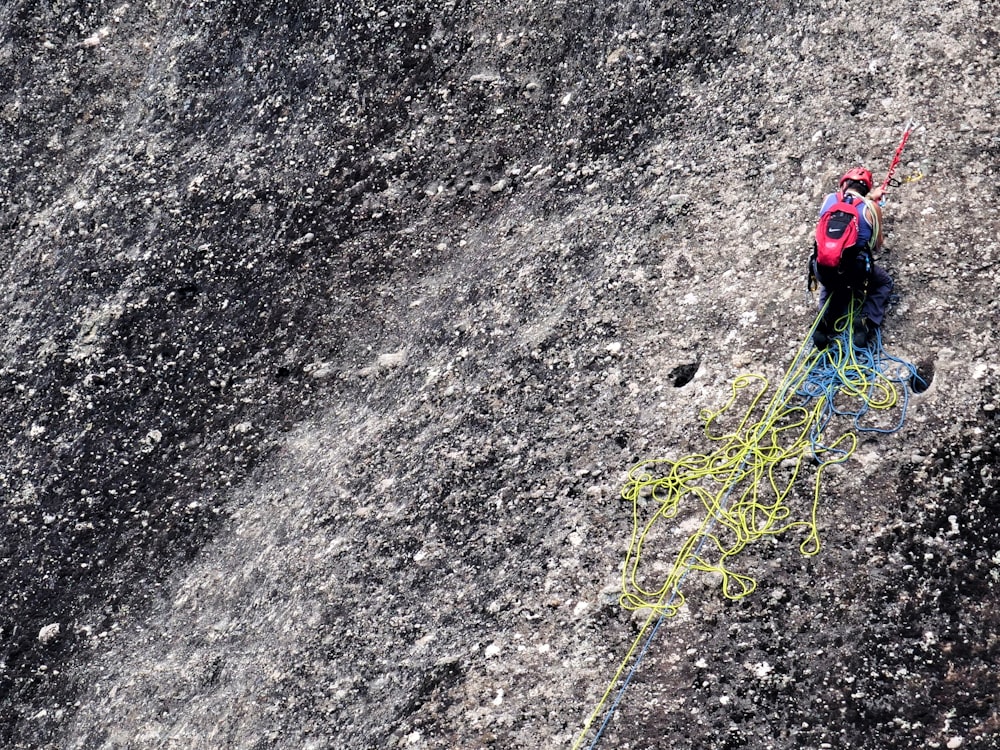 man climbing on mountain