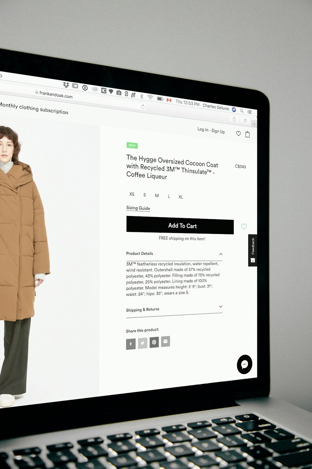 Image of a woman wearing a coat on a turned-on laptop