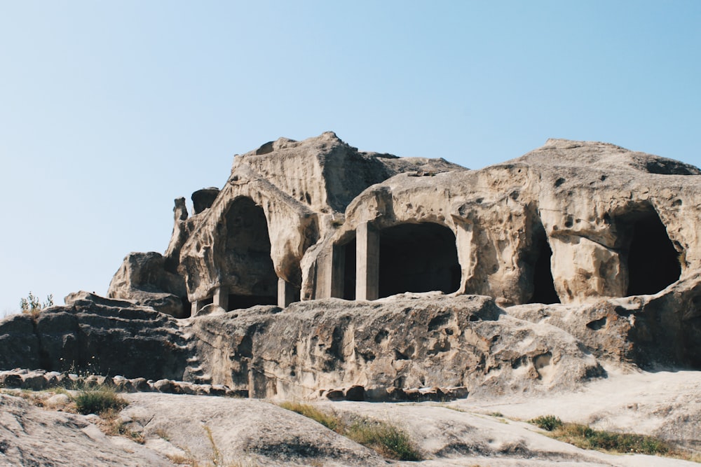 brown rock formation and cave