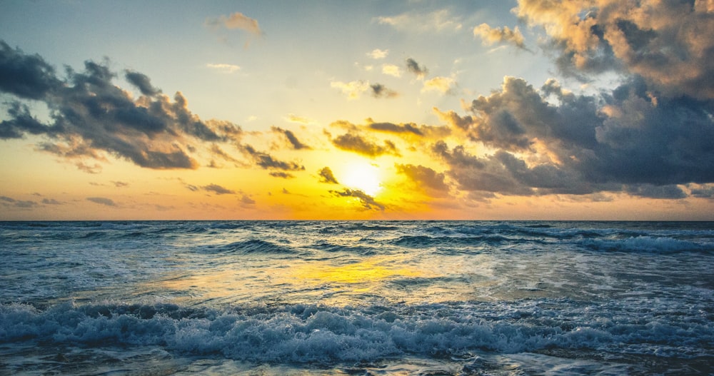 blue sea waves during sunrise