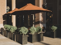 A close-up of durable outdoor umbrellas shading a corporate event seating area.