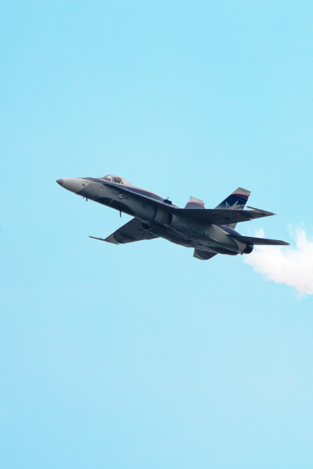 selective focus photography of gray fighter plane on air during daytime