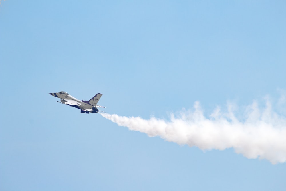 white jet plane in mid air