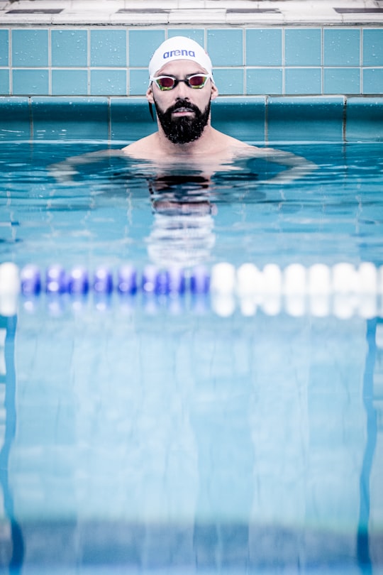 man in swimming poool in Yrjönkatu Swimming Hall Finland