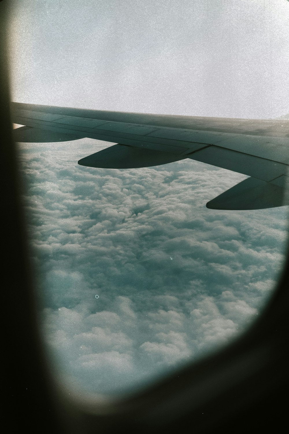 a view of the wing of an airplane in the sky