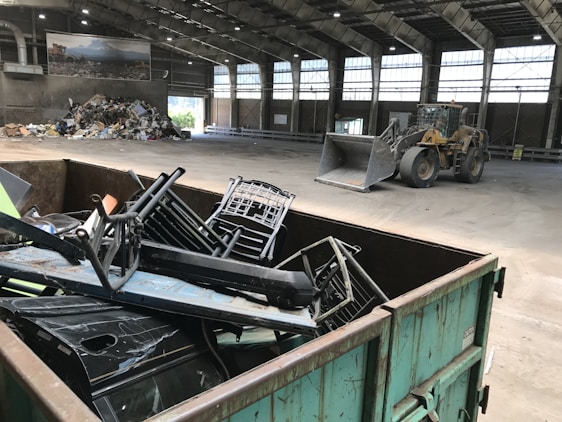 A team of workers sorting and processing various industrial scrap metals in a clean, organized recycling facility.