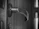 Close-up of a rustic wooden door handle installed on a kitchen cabinet.