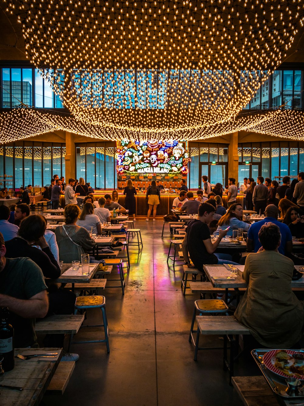 group of people sitting on dining chairs indoors