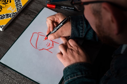 man drawing on white printer paper