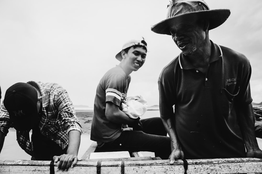 three men standing near railing