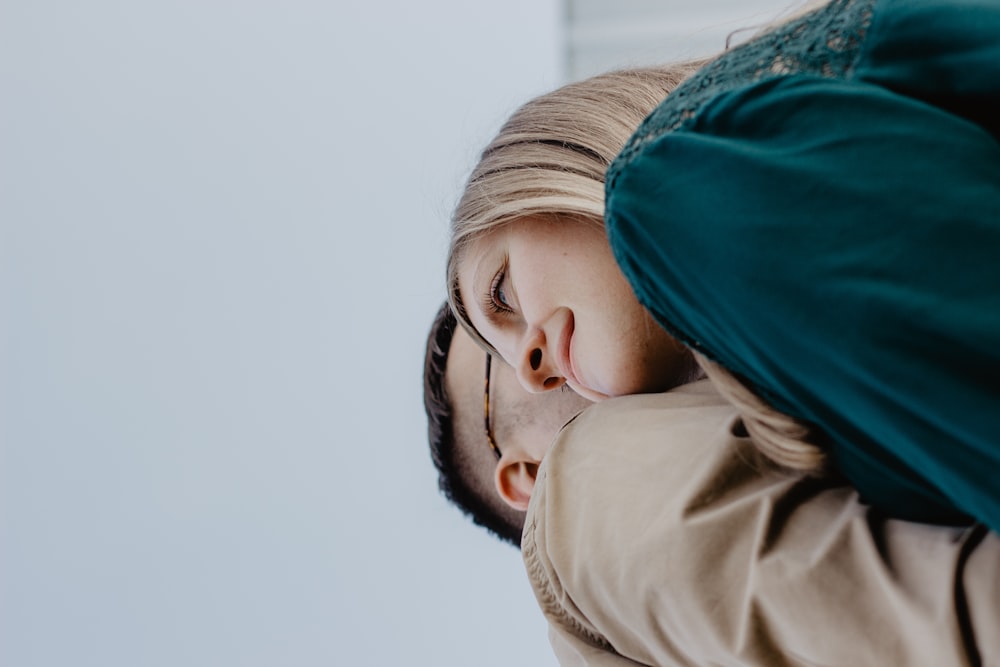 man kissing woman