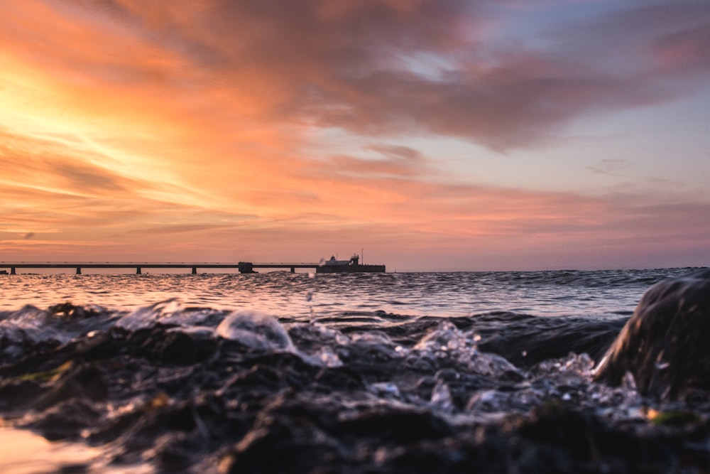 sea water and docking port during sunset