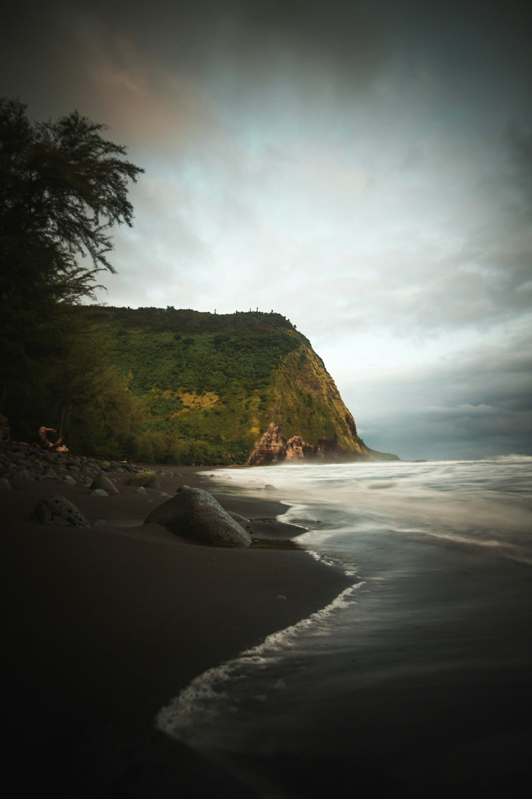 mountain beside beach