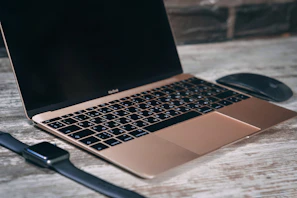 A sleek modern laptop on a clean desk with tech accessories around.