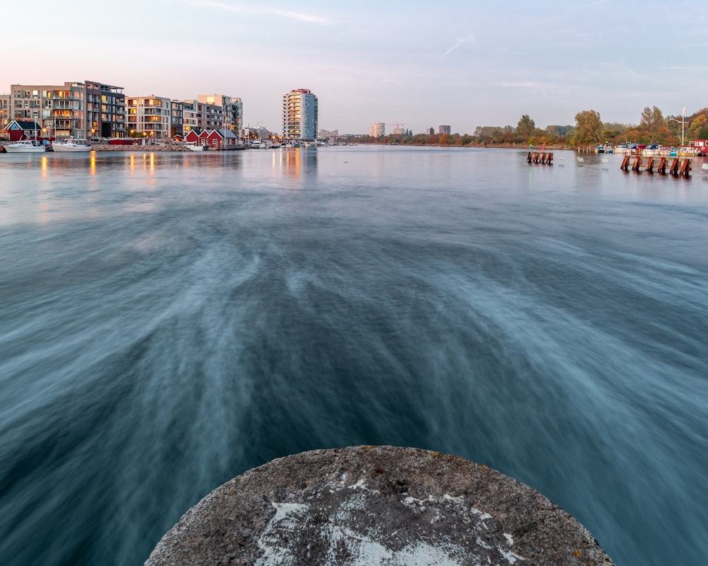 timelapse photography of ocean near buildings during daytime