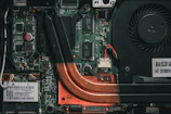An open miner showing intricate circuit boards and cooling fans.