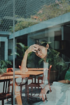 woman touching her forehead