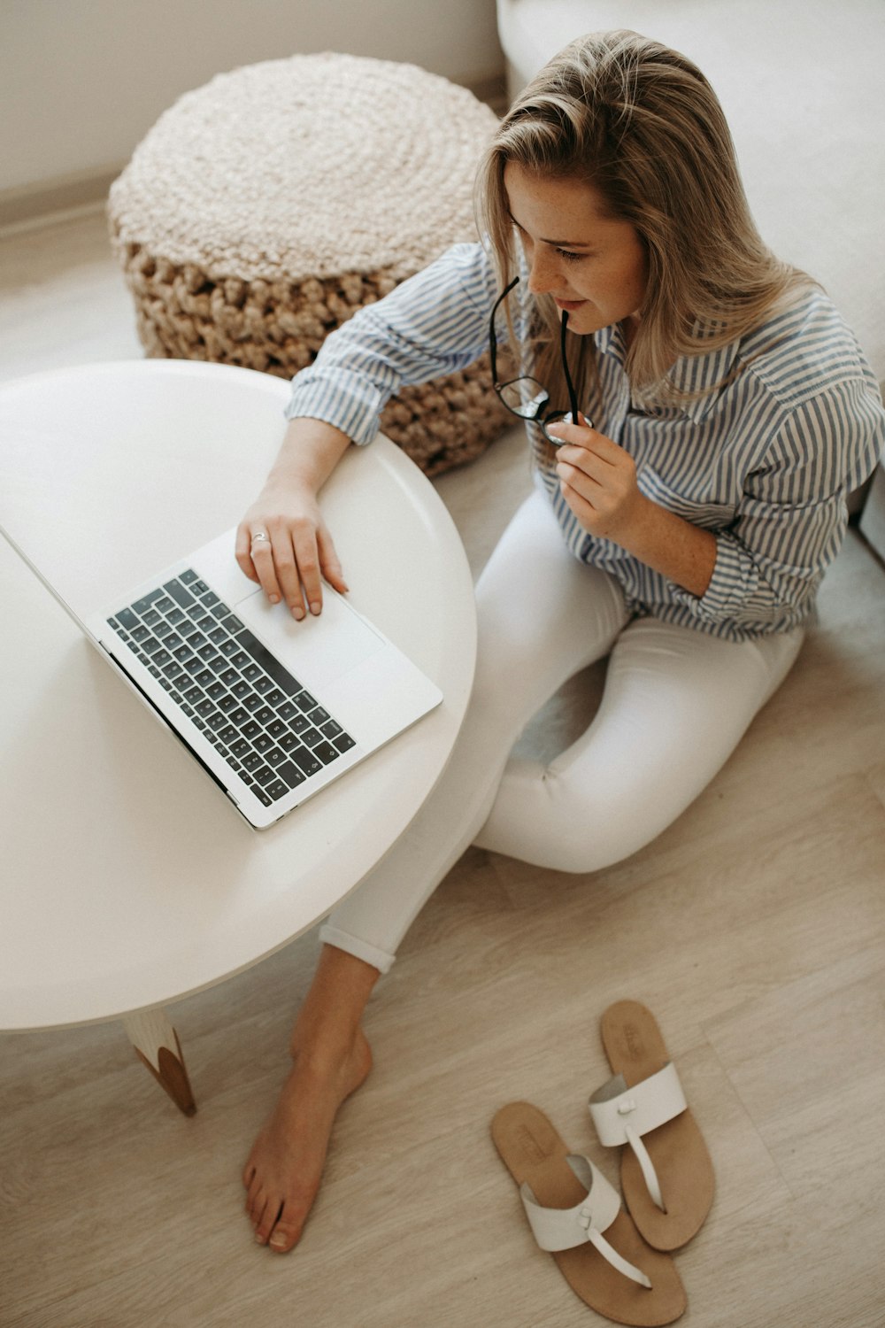 Woman In White And Black Striped Dress Shirt Sitting On Floor In