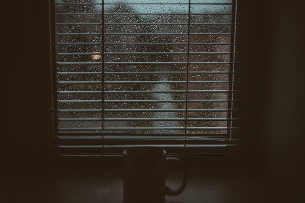 mug near opened window blinds
