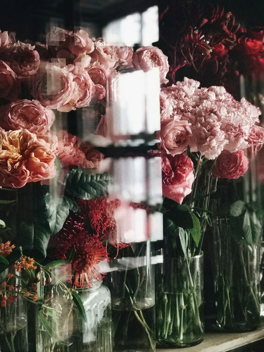 pink and red flowers in display cabinet