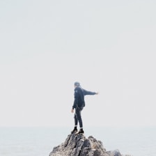 A serene scene of someone confidently stepping forward into a bright horizon.