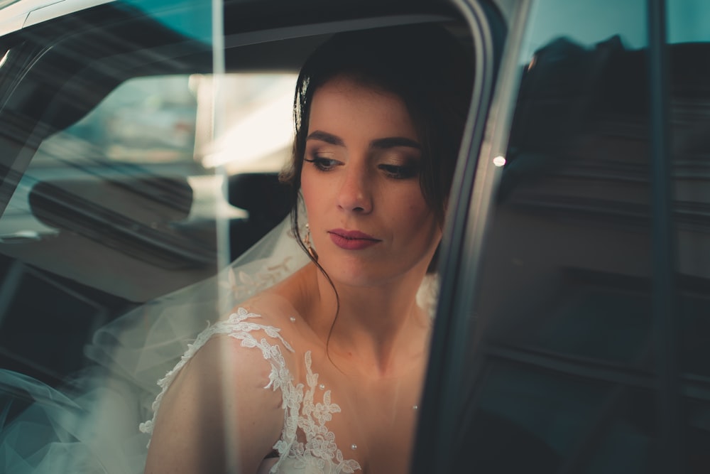 woman wearing veil looking outside window