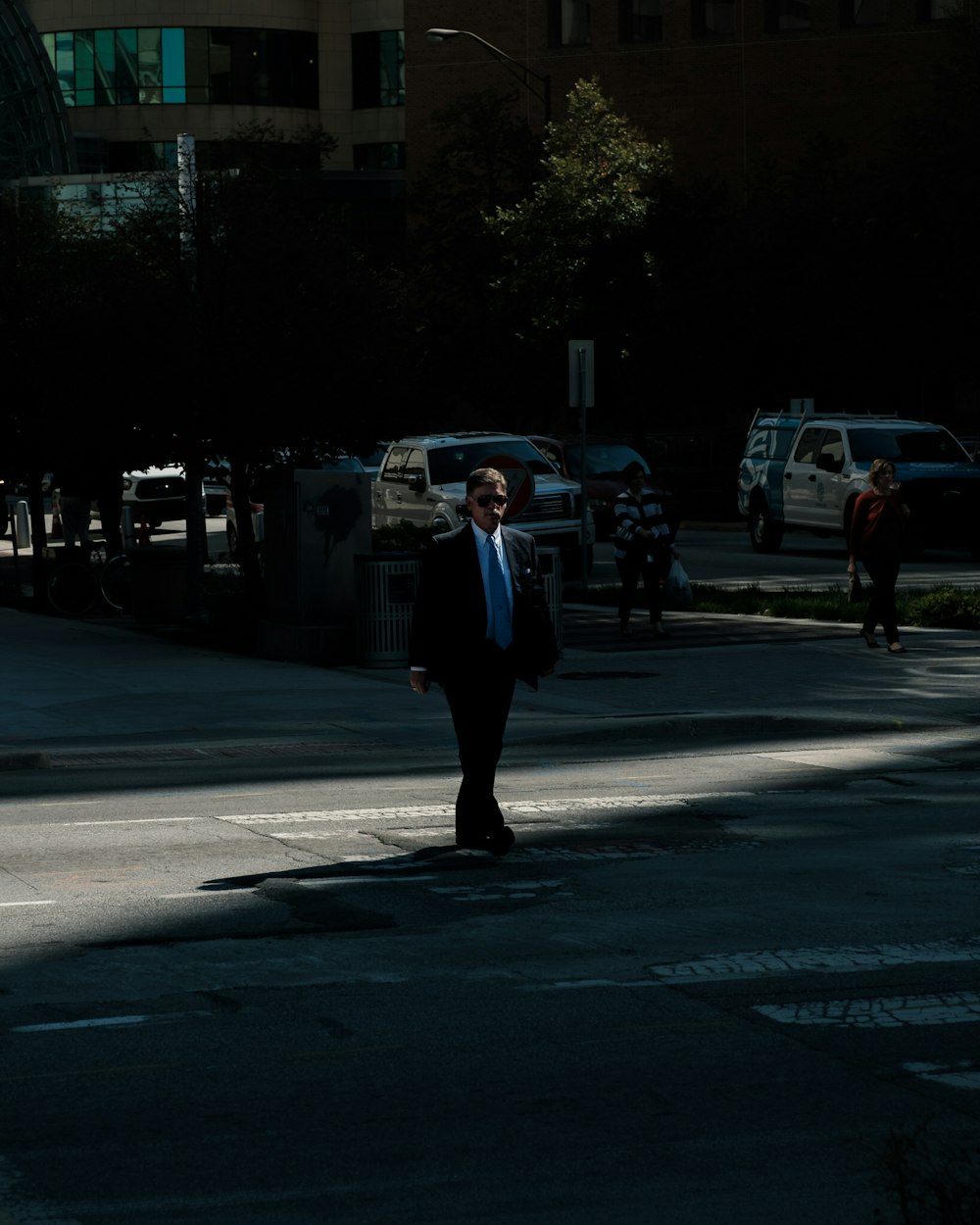 man wearing black suit jacket and blue necktie