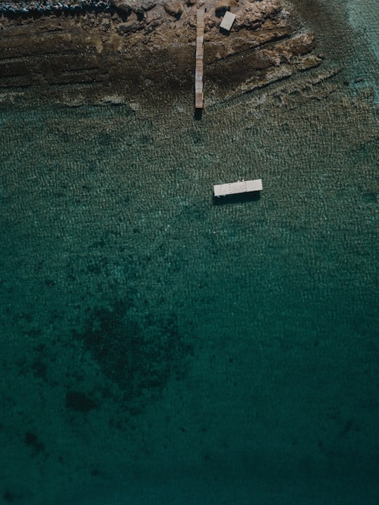 white ferry on sea near cliff in Ξιφάρα Greece