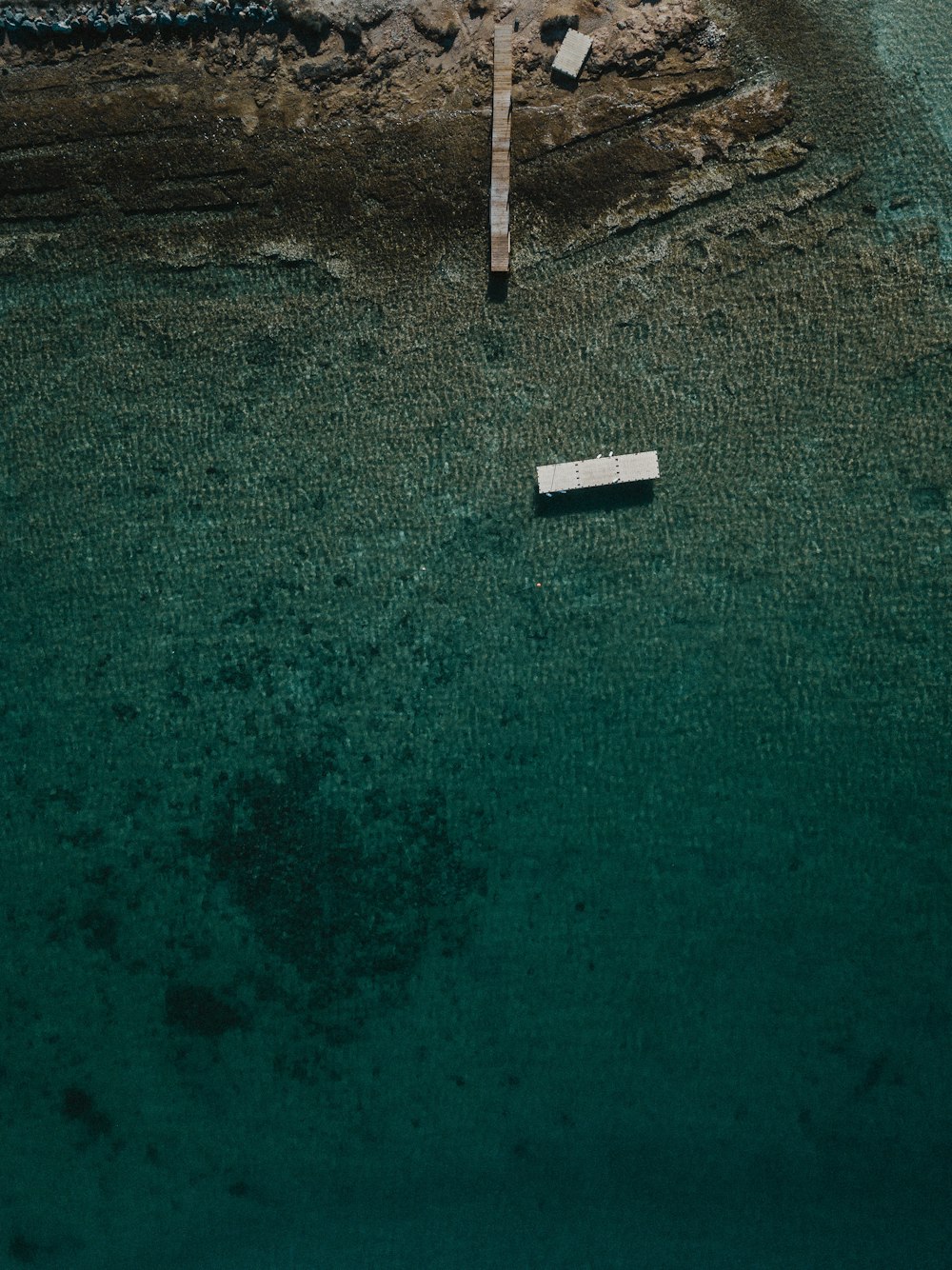 white ferry on sea near cliff