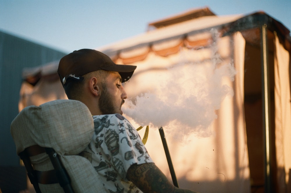 man smoking using vape outdoors
