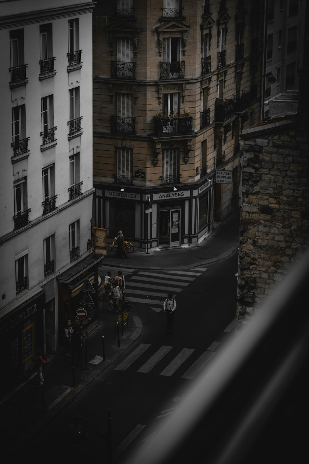 people standing beside high-rise building